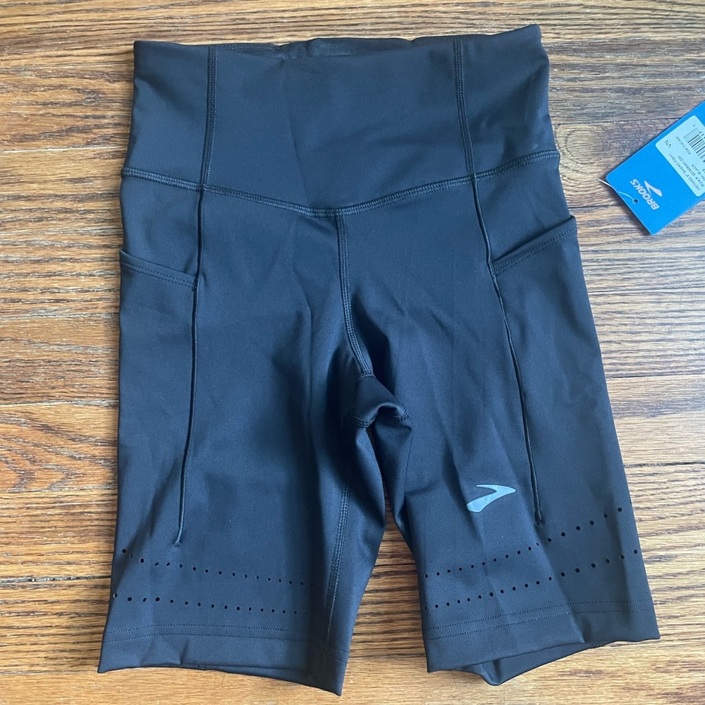 XS brooks 8 inch running shorts. Never worn. Tags still on.